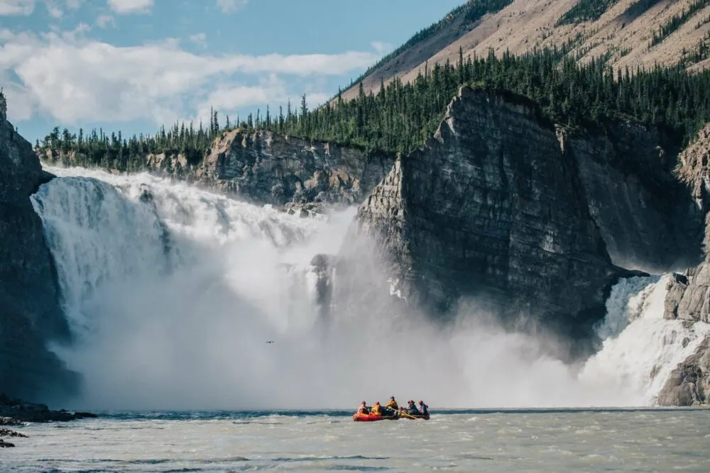 A raft on the Nahanni River in front of Virginia Falls. Official product-page image alt text; representative of the named trip.