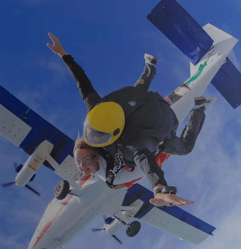 Official page image labeled “Tandem skydive image”; representative tandem-skydiving imagery, not confirmed as a photograph of this specific Palm Dropzone tour.